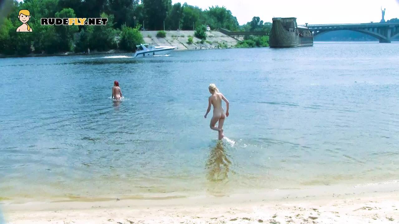 Nudist teens with slim body is enjoying the sun on the rocky beach pic